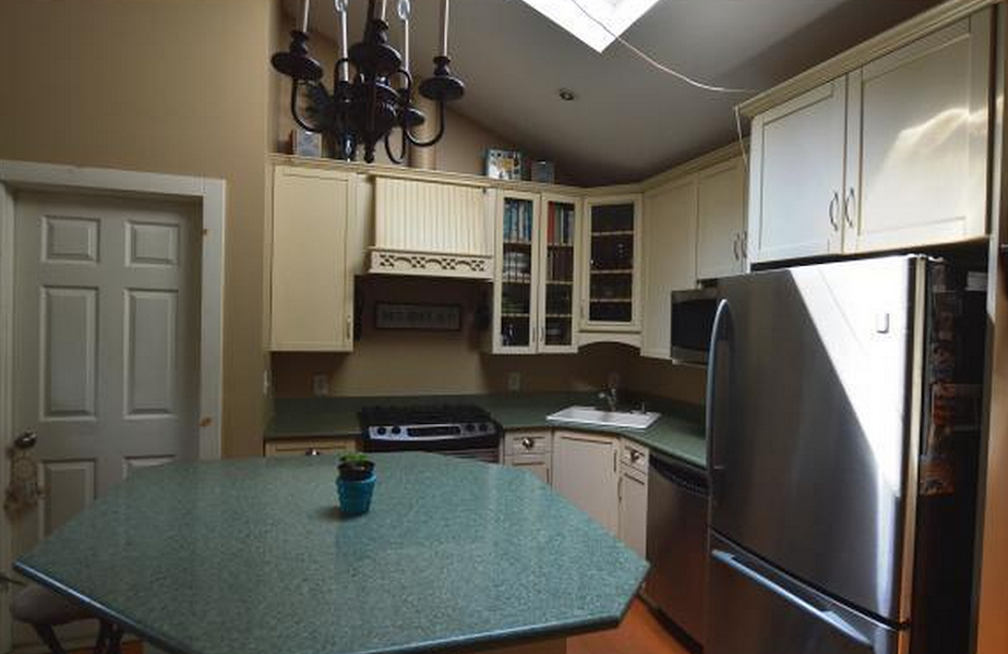Kitchen of the Shelburne home. “We really liked the open concept,” says Ashley. “The island is particularly a nice feature, since instead of a dining room there is a third bedroom. Hardwood and granite definitely were a plus — oh, and those stainless steel appliances really sealed the deal.” - COURTESY OF TRULIA.COM