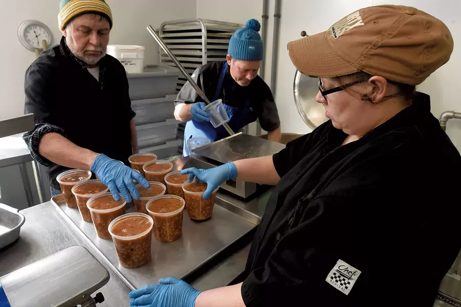 From left: Maurice Martineau, Rob Davis and Victoria Maradiaga Ramos measuring portions of minestrone soup - JEB WALLACE-BRODEUR