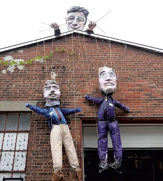 A sculpture of Mayor Miro Weinberger holding puppets of Planning Director David White (left) and Doreen Kraft - COURTESY