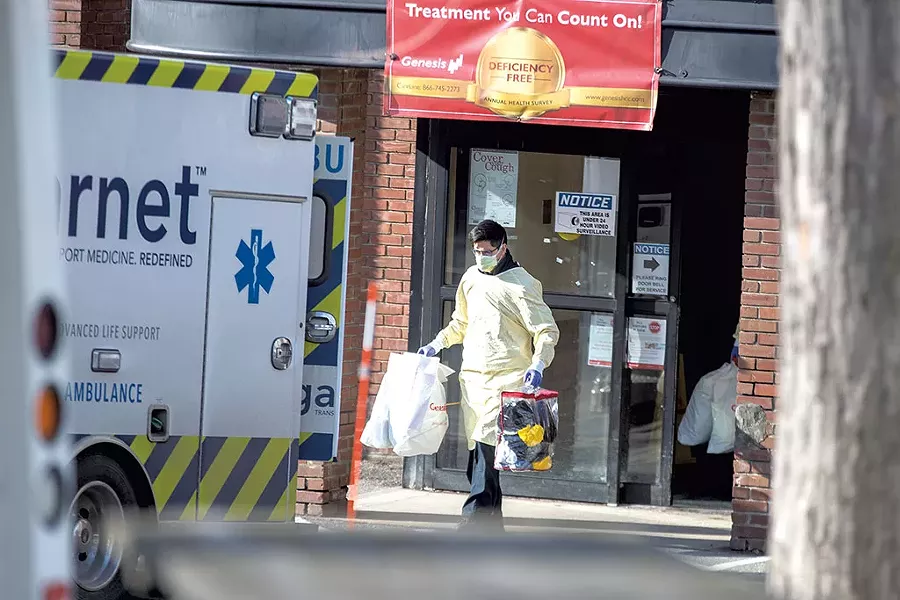 A worker helping to evacuate Burlington Health & Rehabilitation Center patients on Tuesday