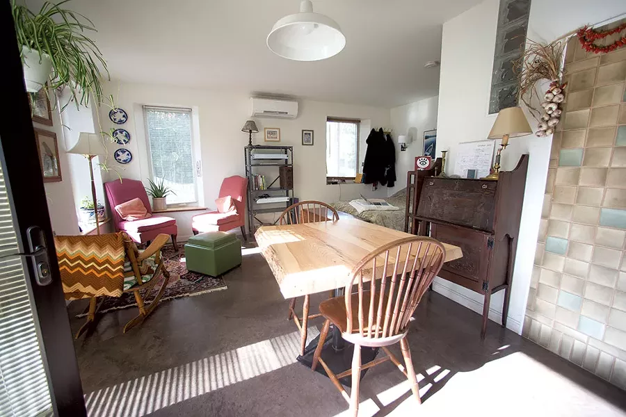 The living space fits a dining table, desk and seating area. - JAMES BUCK