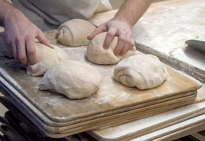 Baker Lucas Diggle shaping loaves - JEB WALLACE-BRODEUR