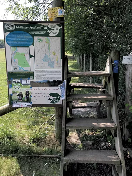 A map and stile along the Trail Around Middlebury - SALLY POLLAK ©️ SEVEN DAYS