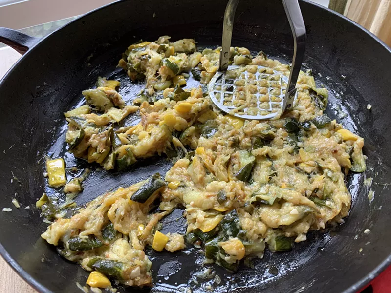 Mashing cooked zucchini and summer squash - MELISSA PASANEN ©️ SEVEN DAYS