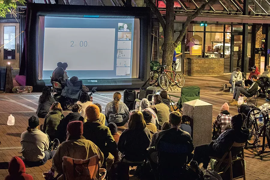 Demonstrators viewing a Zoom city council meeting during a sit-in in front of city hall - JAMES BUCK