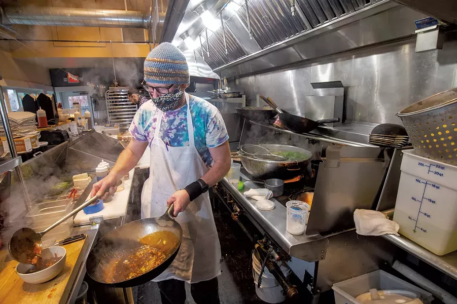 Silas Tanner (front) and Aaron Martin cooking at Umami - JEB WALLACE-BRODEUR