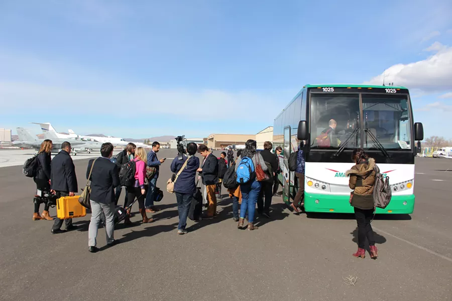 Sen. Sanders' traveling press corps board a bus at Reno-Tahoe International Airport - PAUL HEINTZ
