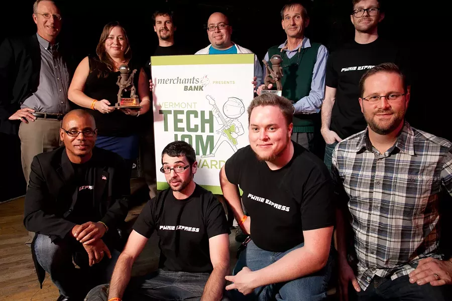 Former Merchants Bank President and CEO Mike Tuttle with 2013 Tech Jam award winners from Pwnie Express and FreshTracks Capital - FILE: MATTHEW THORSEN