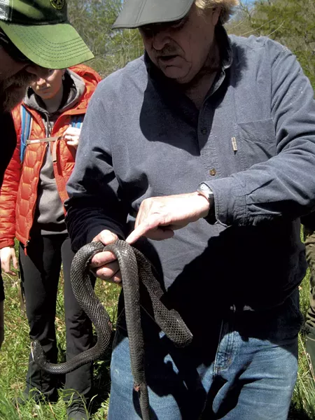 Jim Andrews holding a dead rat snake - ETHAN DE SEIFE