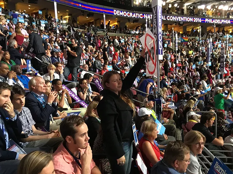 Vermont delegate Ashley Andreas protests as Sen. Bernie Sanders addresses the Democratic National Convention Monday in Philadelphia - PAUL HEINTZ