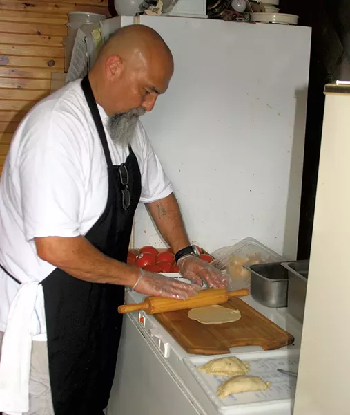 Manuel Aguilera making empanadas - ROBERT C. JENKS