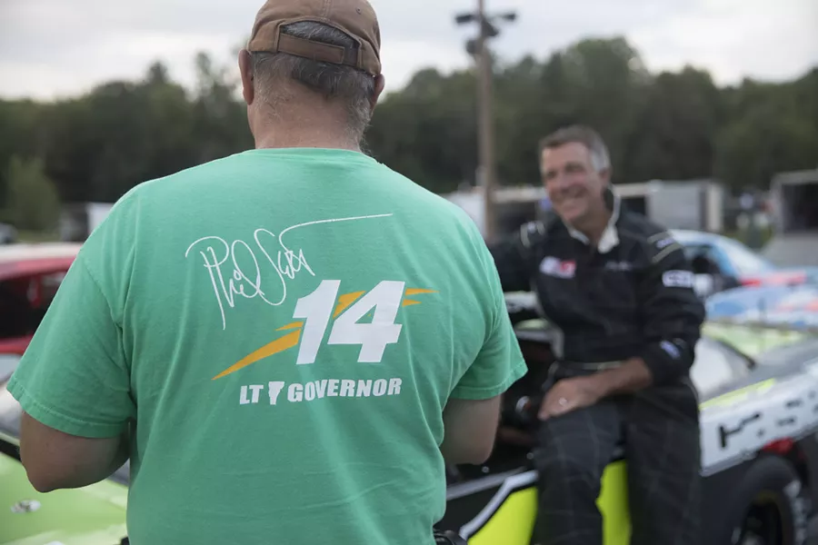 Crew member Jim Morrill talks to Lt. Gov Phil Scott before Scott's race at Thunder Road in Barre on Thursday, Aug 11. - JAMES BUCK