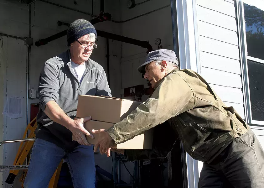 Chef and farmer Joe Buley handing off - a soup order to Gregory Georgaklis - SUZANNE PODHAIZER
