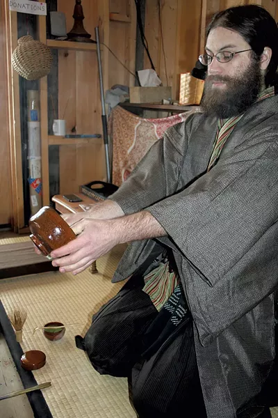 Ben Youngbaer doing a Japanese tea ceremony at Setting Sun Tea Hut - SUZANNE PODHAIZER