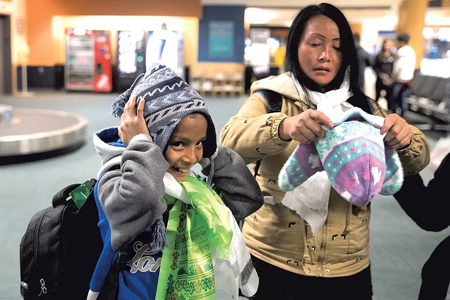 Binod Sharma and Ganga Maya Rai trying on their new winter hats - JAMES BUCK