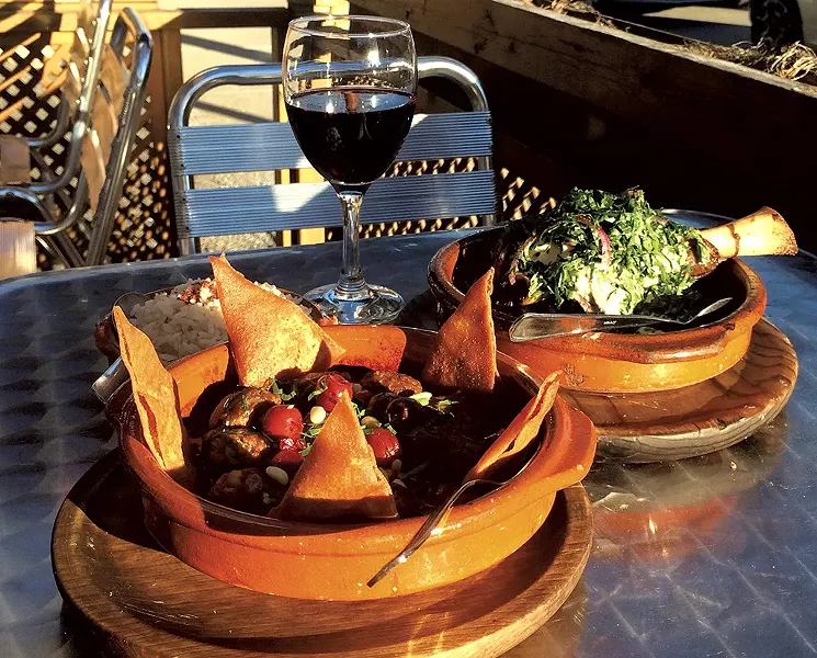 Kefta kebab bil karaz (left), jarret d'agneau (right) and a glass of Ksara's Réserve du Couvent - MOLLY ZAPP