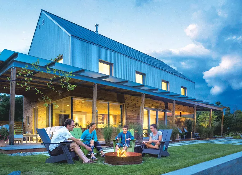 The Hunt family around their Stowe home's outdoor firepit. - JIM WESTPHALEN