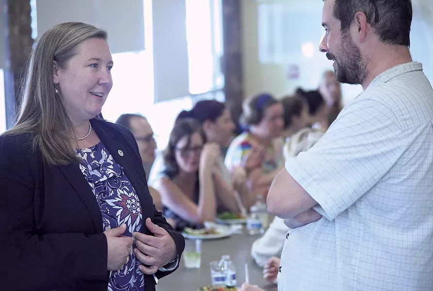 Jessie Baker talking to a Winooski resident at the O'Brien Community Center - MATTHEW THORSEN