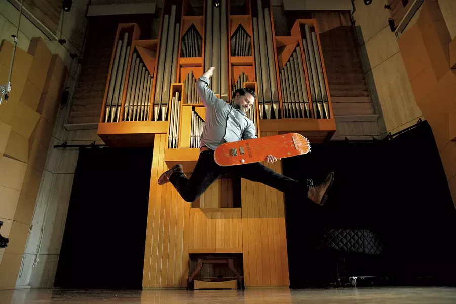 Matt LaRocca playing a guitar he built from an old skateboard - MATTHEW THORSEN