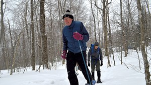 Rep. Curt McCormack and his son, Jamie, snowshoeing up Camel's Hump