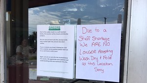 A sign on the front door of a Burlington business