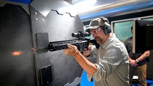 Kevin McCallum firing a Heckler & Koch rifle
