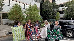 Joyce Irvine, right, with members of the Quilting Queens of National Life Group