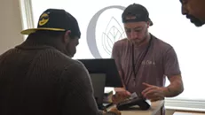 A cashier ringing up a sale at Flora Cannabis in October