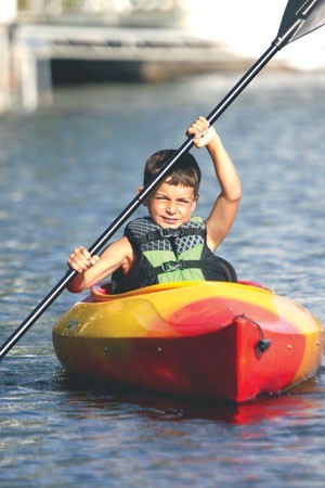 Ben Gilchris, 9, of Barton kayaks on Lake Willoughby. - SHAWN CORROW