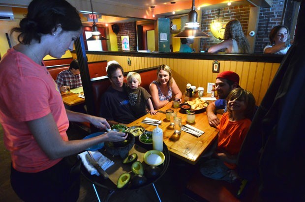 The Jones Godfrey clan, including Carter, 3, left, and Mason, 6, get tableside guacamole at Frida's in Stowe.