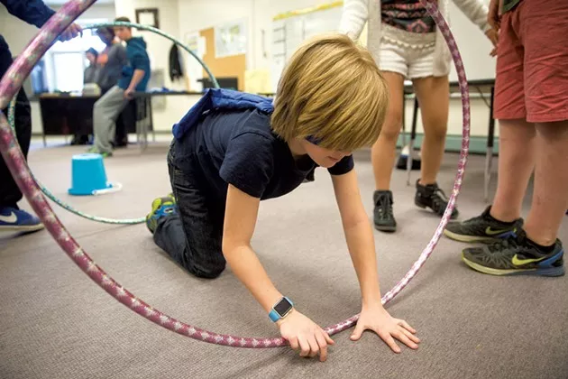 George Francisco navigating an obstacle course while blindfolded at Williston Central School