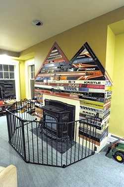 25 pairs of skis were mounted behind the playroom's pellet stove - JEB WALLACE-BRODEUR
