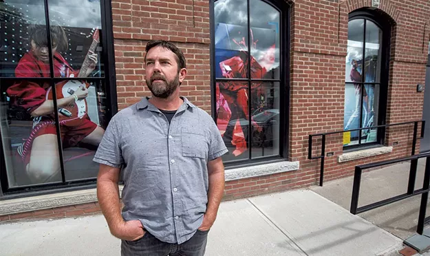 Rock and Roll Photos Paper the Windows of a Waterbury Building - Vimarsana News