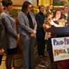 Christine Vance holding her son, Ben, as she addresses supporters of paid family leave in the Statehouse on Wednesday