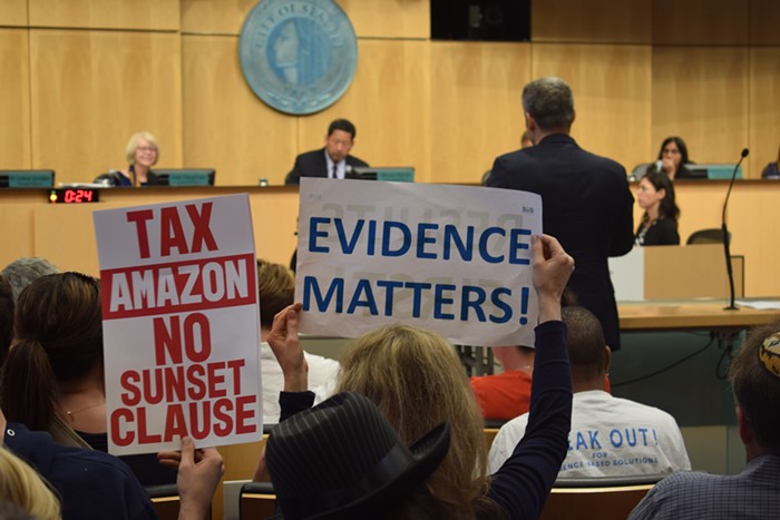 Dueling signs at City Hall over the head tax. Dueling signs at City Hall over the head tax.