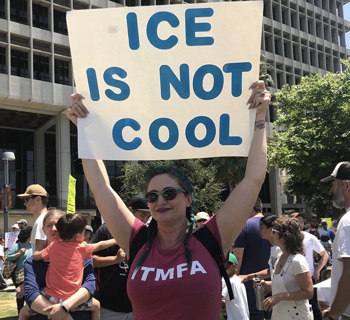 Two Pieces of Inspired Signage at Families Belong Together March in LA