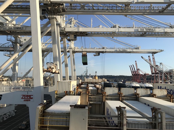 Flying cows!! Animals ship in livestock containers. (Holes allows for breathing, Thompson says.) But when the time comes to remove the containers from the boat, the cranes lift the livestock containers off the ship just like any other cargo.