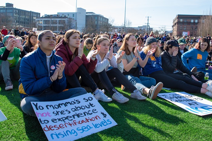 Paola Quijada (left) claps for the opening remarks at the Youth Climate Strike at Cal Anderson Park. There were a lot of of clever signs, but few could match Quijadas brilliant mix of 2000s humor and climate science.