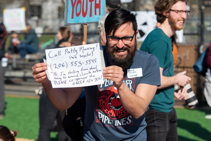 Ahmed from the Sunrise Movement shows a group of students the number for Washington Senator Patty Murray to urge her to support the Green New Deal. His table was hosting seminars on calling your representative and educating people about the Green New Deal.