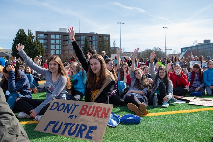 A group of students raise their hands high when the speakers asks how many attendees are under the age of 16. The majority of hands shot into the air, showing just how much this strike was powered by youth action.