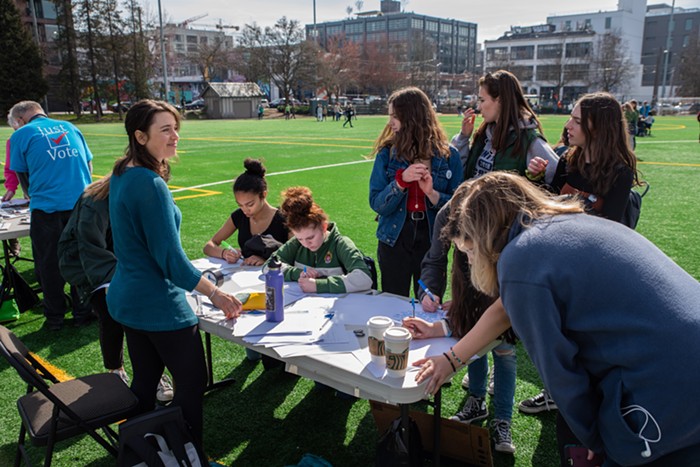 Students write letters to their representative at one of the several political outreach tables.