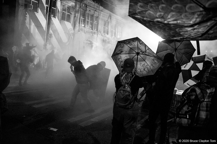 A cloud of tear gas billows over retreating protestors. Mayor Durkan and Police Chief Best had just stated at a press conference that tear gas would no longer be used. This was tear gas.