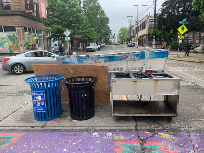 The new barriers are made of trash cans, wood panels, and a deep fryer.