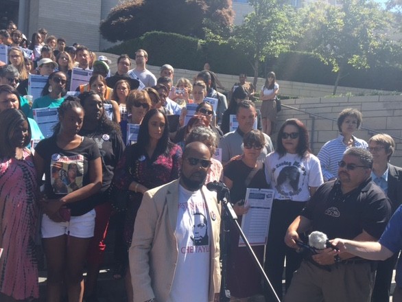 Andre Taylor, an organizer whose brother Che Taylor was shot by Seattle police, announces support for a new police accountability initiative on City Hall steps.