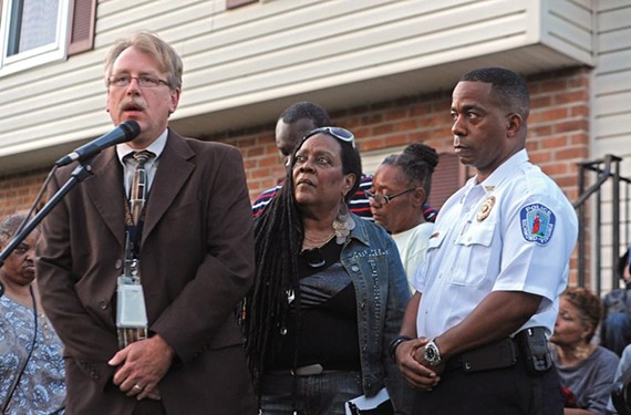 At a vigil for Lewis James Johnson Jr., Richmond police Capt. Brian Russell, left, with Alicia Rasin and Chief Bryan T. Norwood, asks onlookers for information that could help the young man’s killing. - SCOTT ELMQUIST
