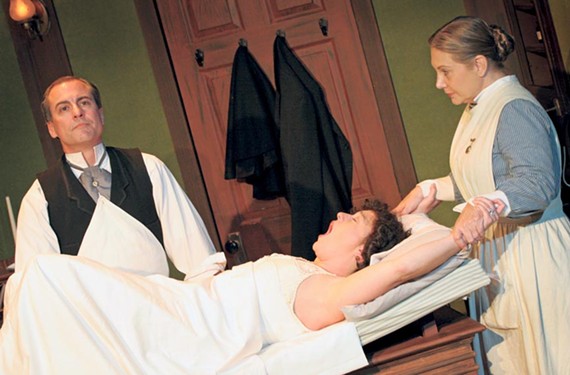 Dr. Givings (Larry Cook) prepares to treat a patient (Laine Satterfield) for hysteria as Annie the nurse (Lauren Leinhaas-Cook) looks on. The Victorian-era vibrator used on set was found in a Petersburg antique shop for $15. - JAY PAUL