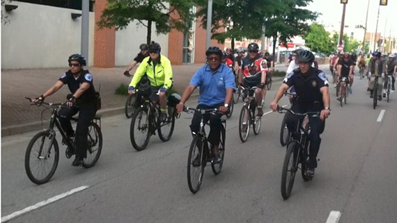 Flanked by two police officers, Richmond Mayor Dwight Jones leads cyclists on a ride to City Hall marking National Bike to Work Day. - NED OLIVER