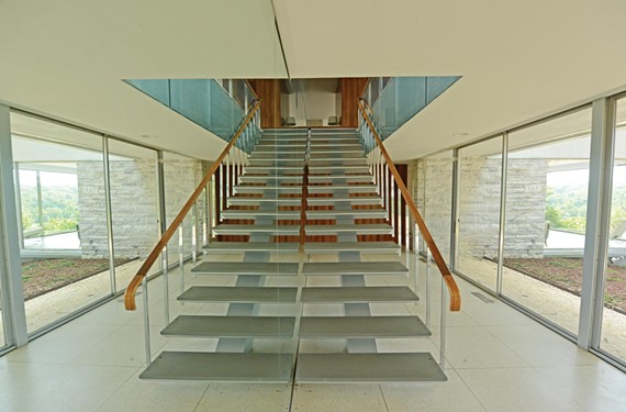 In the foyer, Neutra set a floating staircase against a mirrored wall, a feature that heightens the sense of space and accentuates the vista of the James River. - SCOTT ELMQUIST