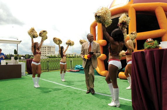 Mayor Dwight C. Jones revels in the grand opening of Redskins Training Camp on July 8. What followed was a three-week spectacle of feverish fandom and boosterism, though it’s uncertain whether the city will recoup a near $15 million investment. - SCOTT ELMQUIST