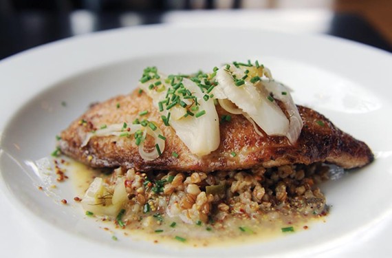 The roasted catfish at the Roosevelt comes with South Carolina farro dirty rice and mustard butter.
